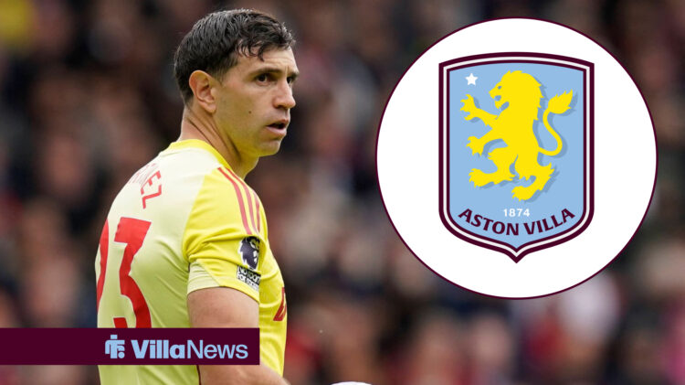 Aston Villa goalkeeper Emiliano Martinez stares at the club's badge.