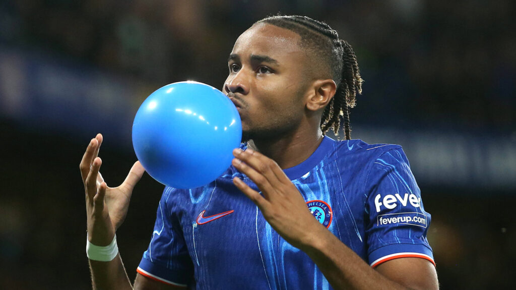 Christopher Nkunku blowing a balloon after scoring for Chelsea