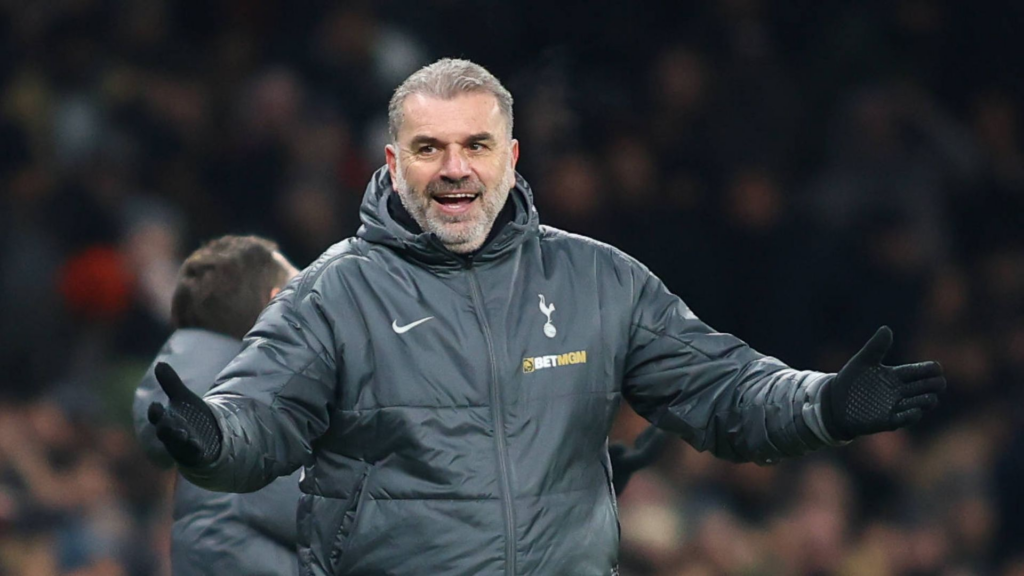 Ange Postecoglou looking happy in a Tottenham coat