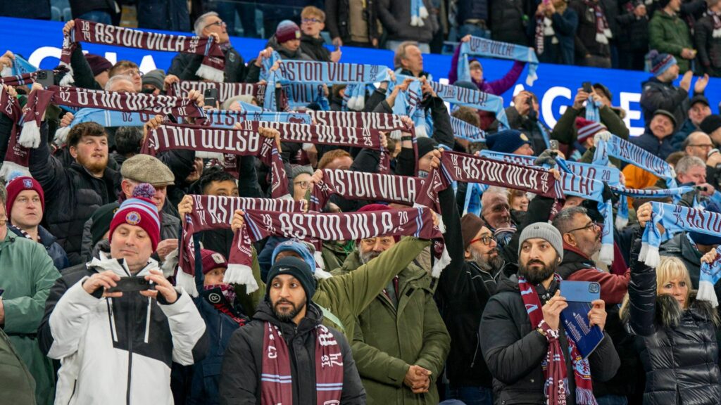 Aston Villa fans holding up scarfs at Villa Park