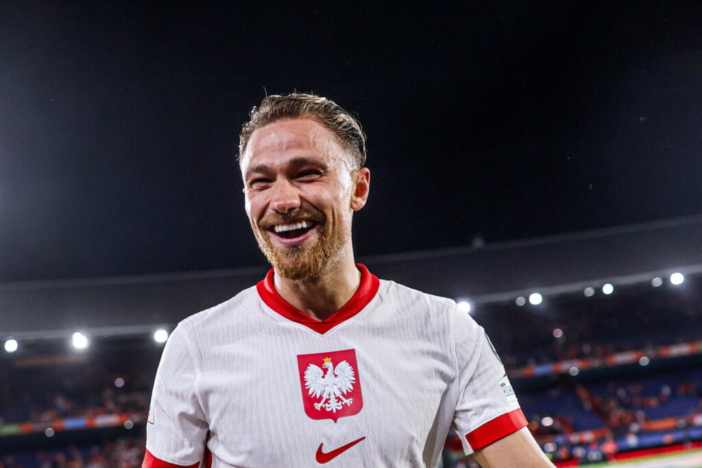 Matty Cash smiling while playing for Poland