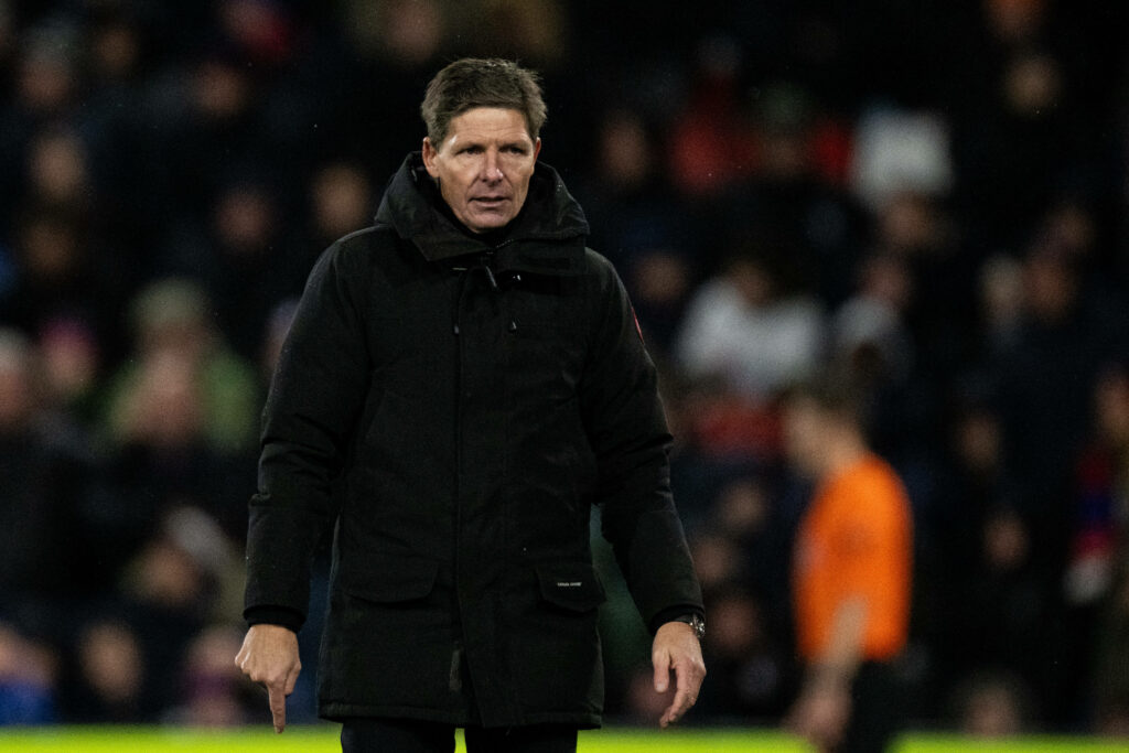 Oliver Glasner looking frustrated on the sidelines in a black coat