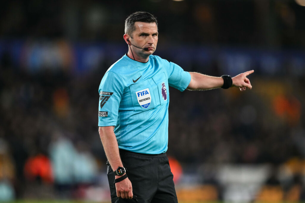 Michael Oliver holding his hand out pointing
