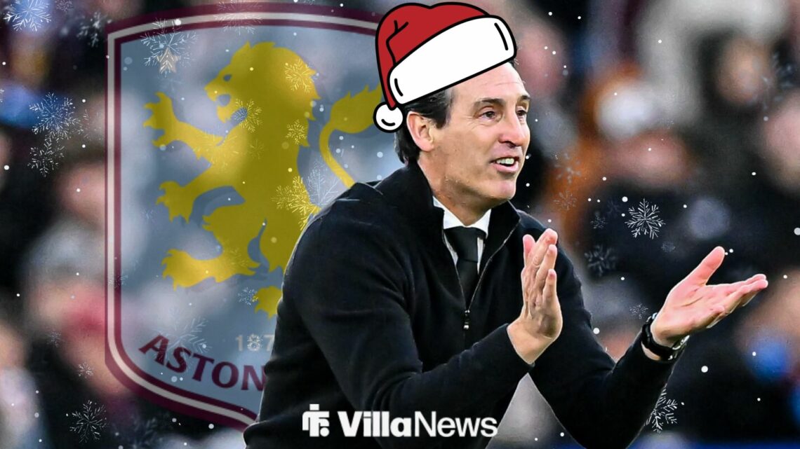 Unai Emery clapping in a santa hat with an Aston Villa badge behind him