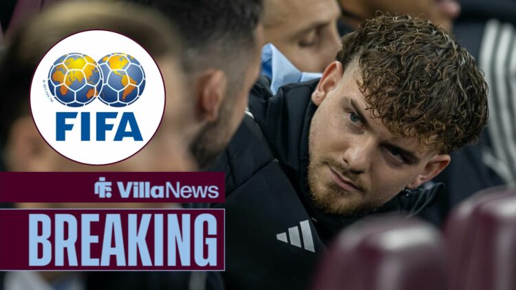 Harvey Elliott sitting on the bench for Aston Villa looking towards the FIFA logo in a circle inset
