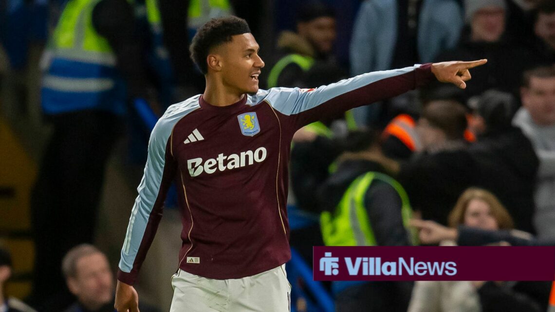 Ollie Watkins with his arm stretched out.