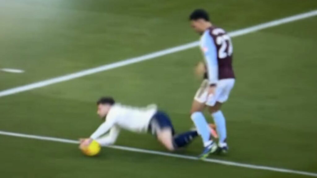 Neco Williams going down for Nottingham Forest under pressure from Morgan Rogers of Aston Villa