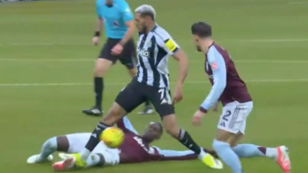 Joelinton putting in a tackle on Amadou Onana