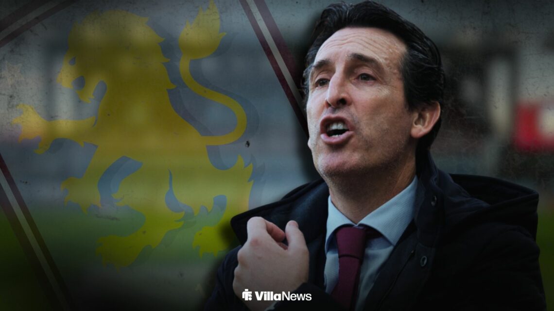 Unai Emery shouting standing infront of an Aston Villa badge